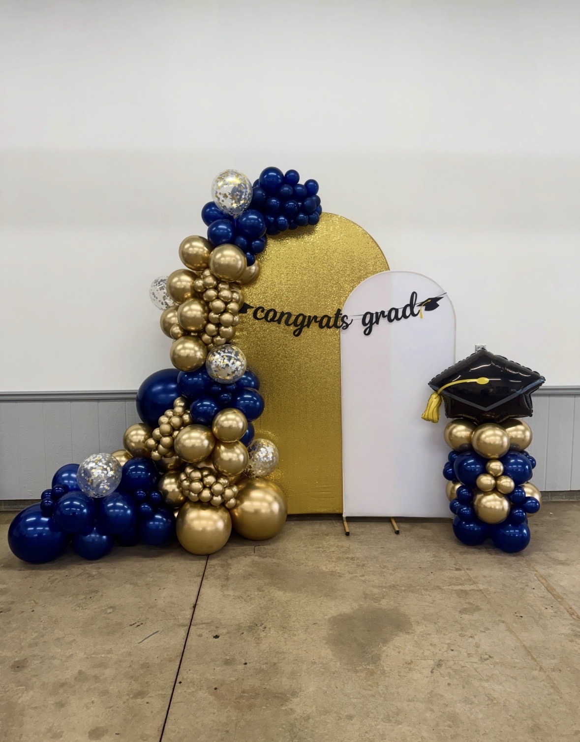 Navy, gold and silver confetti graduation balloon garland with gold arch and matching column